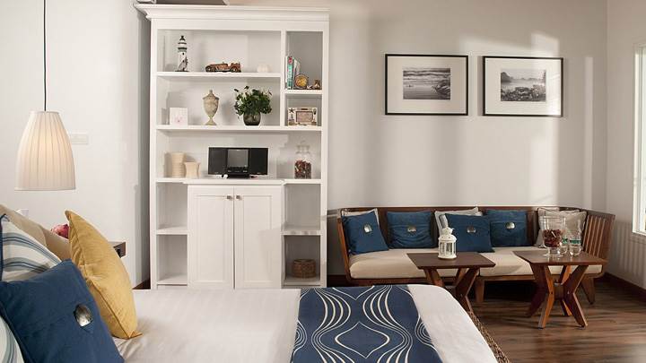 White Interior In Bed Room And Wooden Sofa And Table
